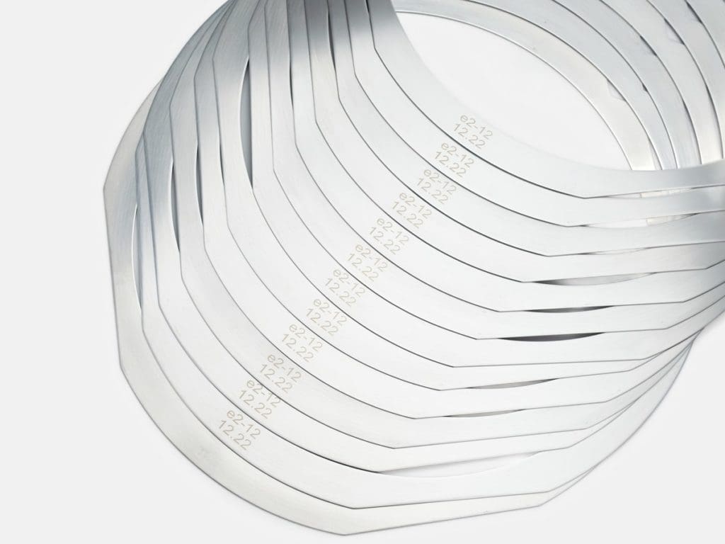 Laser-marked metal film frames fanned in a stack